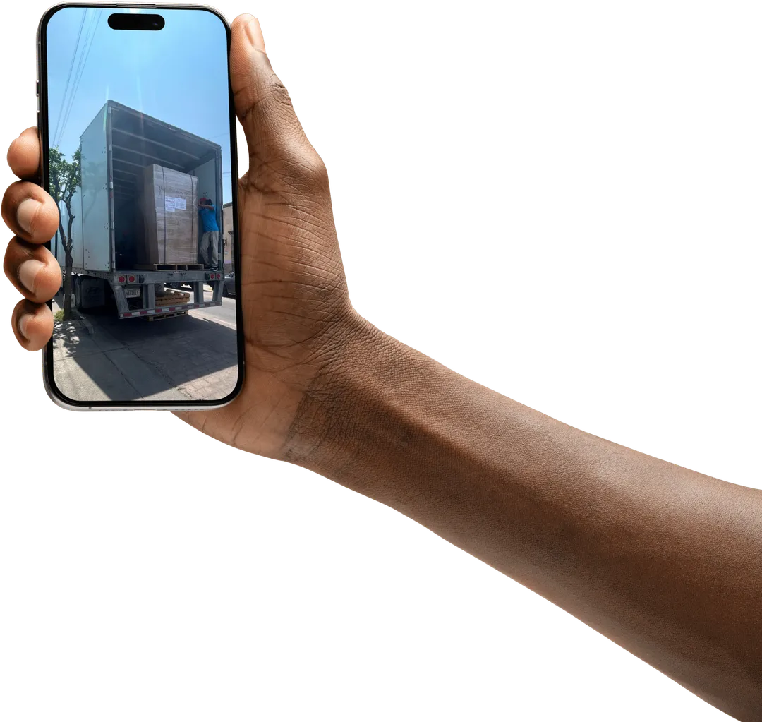 Hand holding a phone showing a shipment ready for dispatch